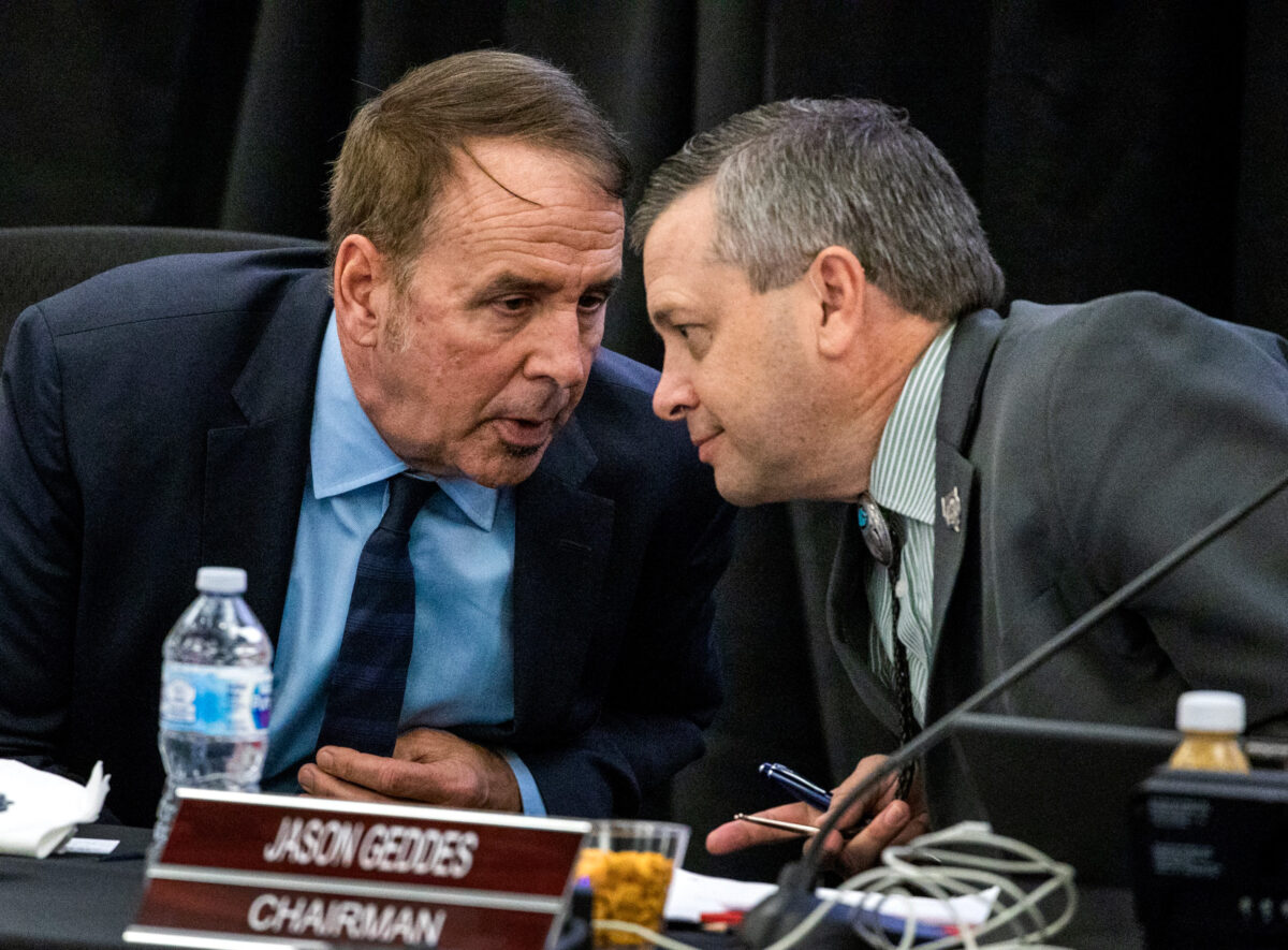 Former Nevada System of Higher Education Chancellor Thom Reilly, left, talks to Jason Geddes, chairman, during the Board of Regents quarterly meeting at UNLV on Friday, Dec. 6, 2019. (Jeff Scheid/Nevada Independent)